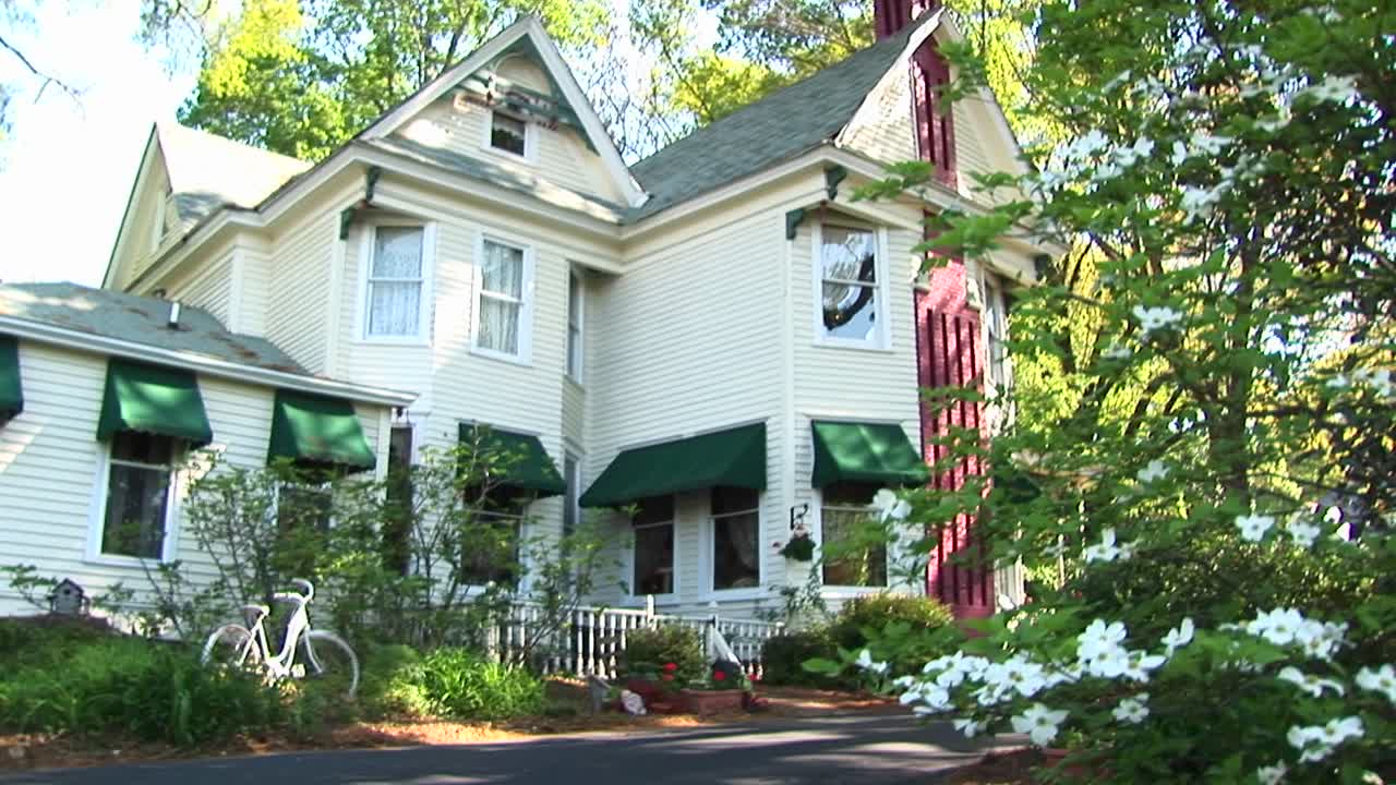 Camera Zooms In From Across The Street To A First Floor Window Of A Victorian House