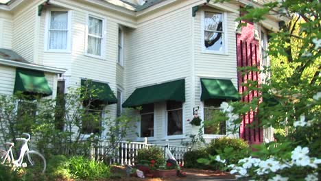 Camera-Zooms-In-From-Across-The-Street-To-A-First-Floor-Window-Of-A-Victorian-House