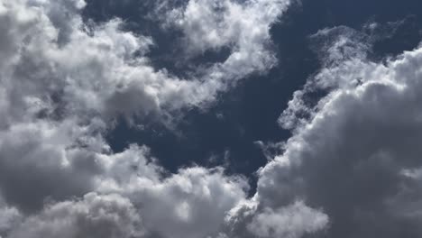 timelapse of blue sky with fast moving white fluffy cloud