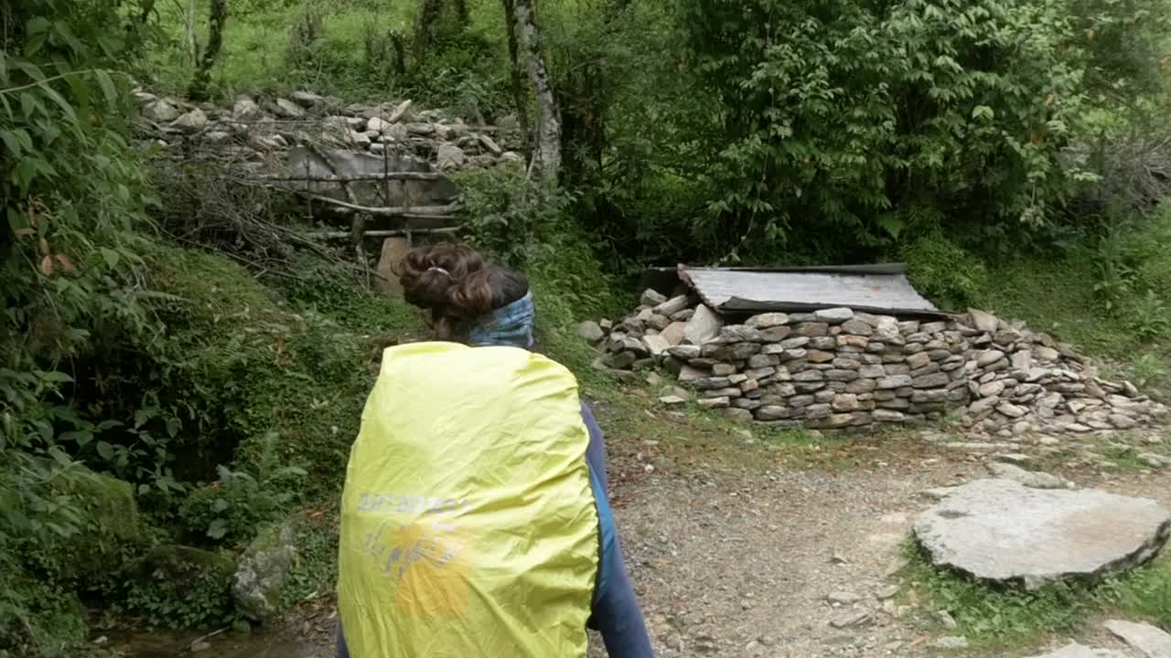 mujer joven caminando por el camino en el himalaya nepal, región de annapurna, cámara lenta