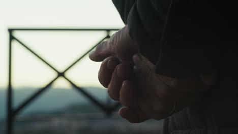 hand of an elderly country gentleman moves in silhouette in the village