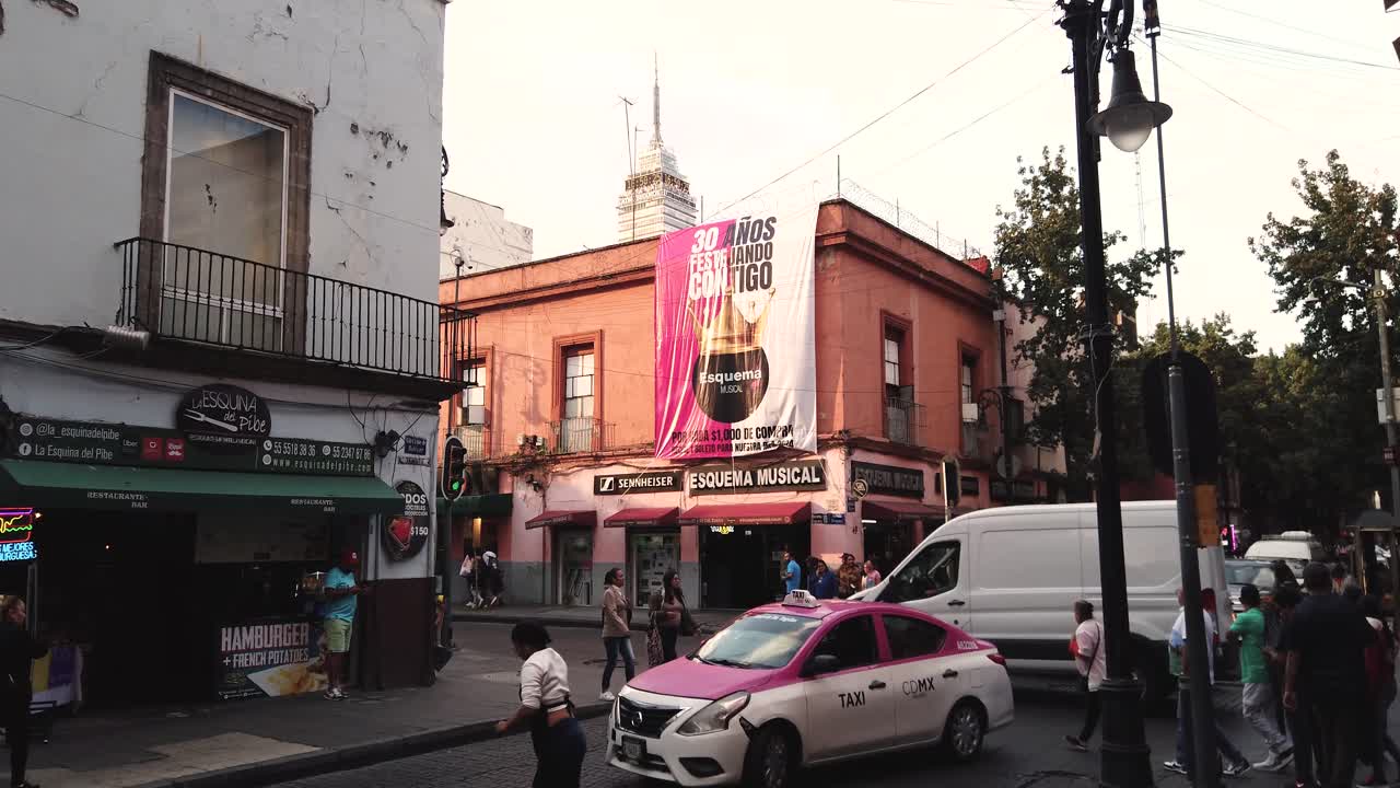 Static slow-motion shot of the intersection of Simón Bolívar and República de Uruguay streets at sunset in the heart of Mexico City