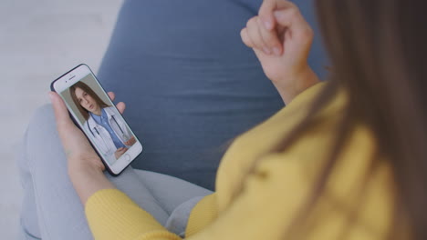 Doctor-or-therapist-help-releave-stress-from-coronavirus-crisis-video-conference-call-online-live-talk-remotely-with-woman-sit-on-sofa-couch-at-home-using-smartphone-doctor-consultation.