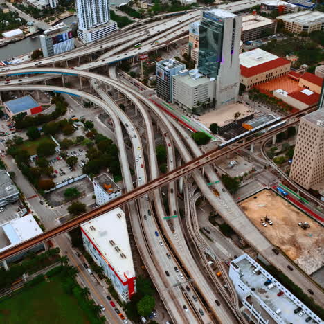 cars move by the multiple freeways in the metropolis downtown. cityscape of miami, florida, usa from top.