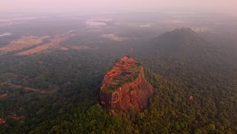soaring above the misty jungles of sri lanka, this drone clip captures the iconic sigiriya rock at sunrise.
