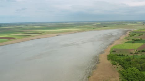 open water lake surrounded by green plains at nature reserve slano kopovo in novi becej, serbia. aerial