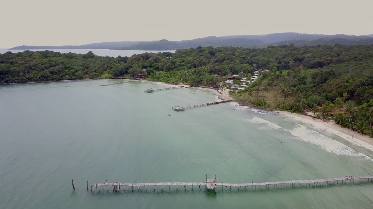 Ko Kut beach aerial view with pier, lush greenery, peaceful coastal scene