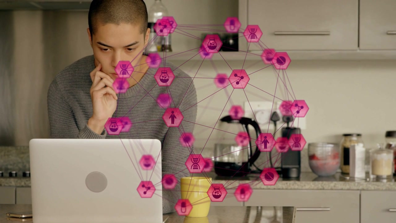 Uomo chinato verso il laptop, con nodi esagonali rosa in crescita che si sovrappongono alla sua figura, al portatile e a una tazza, in un contesto tecnologico.