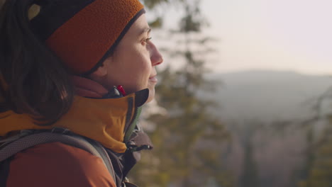 woman enjoying view of winter nature from mountain
