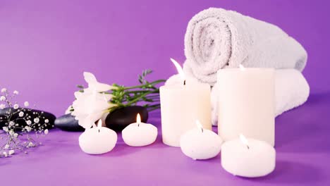 Pebbles,-candle,-towel-and-flowers