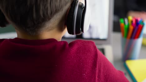 video of boy in headphones during homeschooling