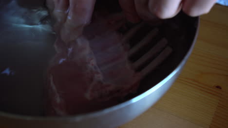 Chef-washing-a-rack-of-lamb,-food-preparation