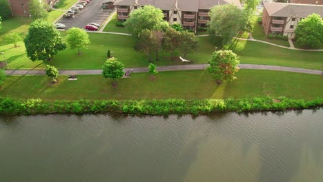 rising-aerial-above-lake-Big-Bear-Lake-in-Century-Park-from-Vernon-Hills-Illinois-USA-while-bird-enters-frame