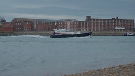 boat passes the beach in the harbour