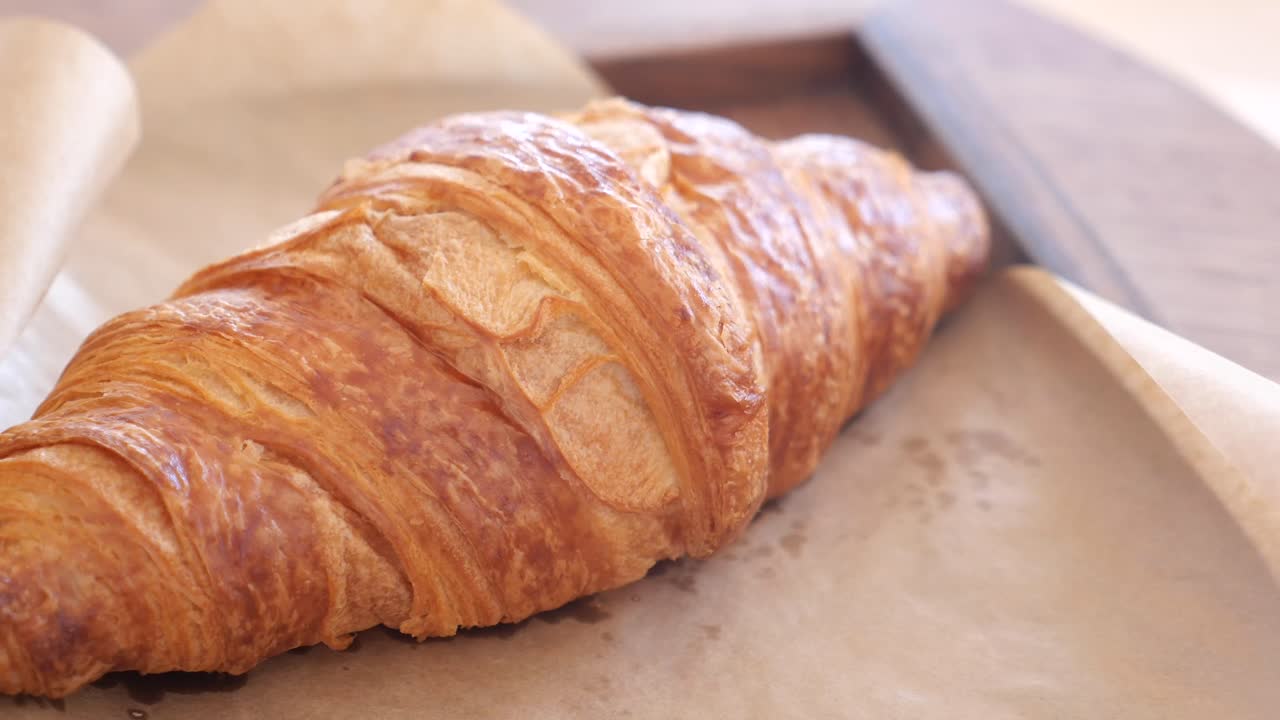 Delicious Croissant on a Wooden Tray