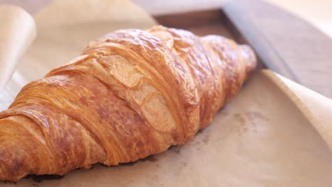 delicious croissant on a wooden tray