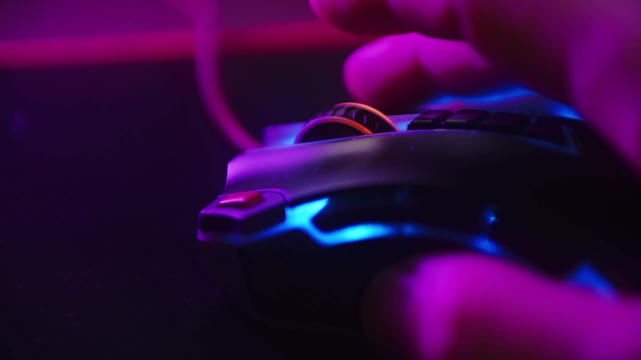 Close up shot of a hand scrolling the mouse wheel while playing games and clicking on a computer