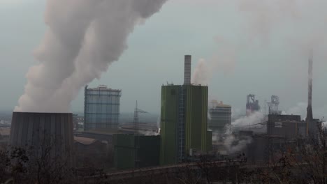 steam rising from cooling tower at large german steel factor in duisburg nrw