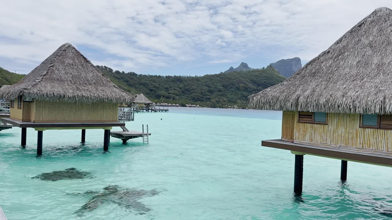 Summer Bora Bora Vacation Resort in French Polynesia with turquoise and aquamarine shallow lagoon clear water