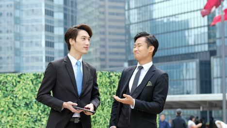 two young businessmen meeting on outdoors