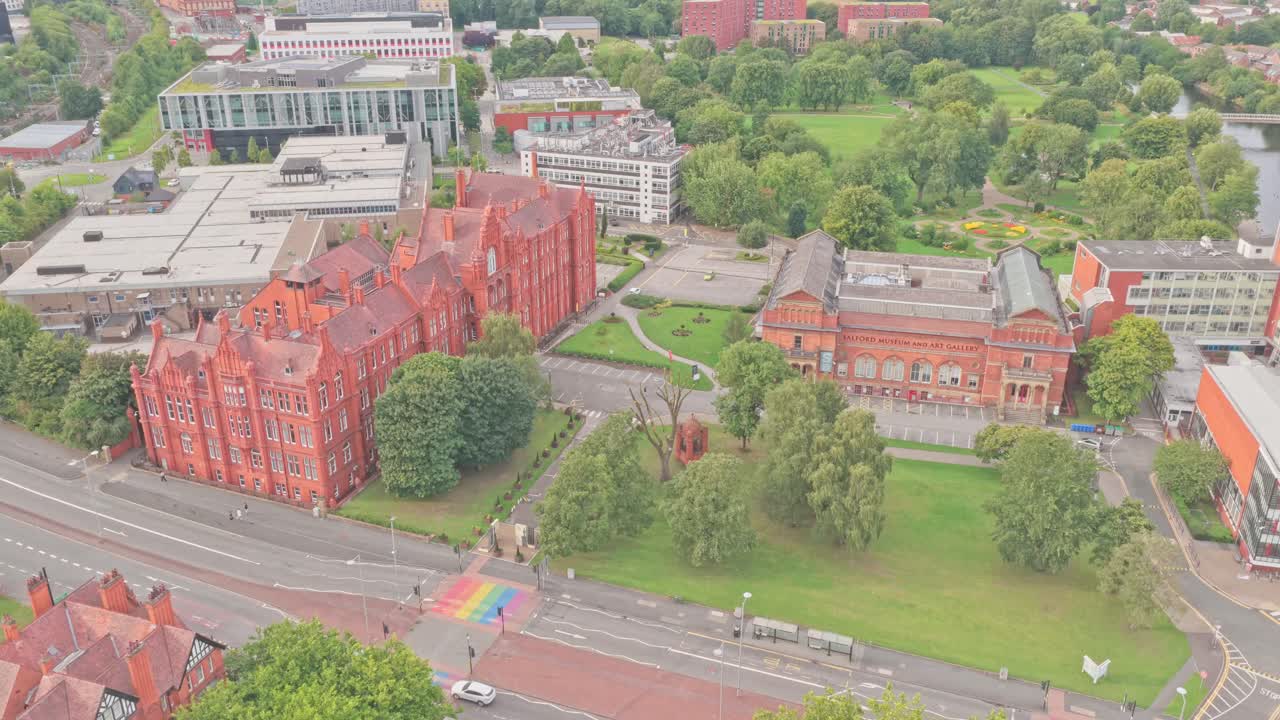 Aerial shot of the University of Salford campus at Crescent, showing Peel Building, Salford Museum and Art Gallery, with Peel Park and River Irwell in the background