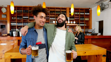 friends toasting glass of beer at counter 4k