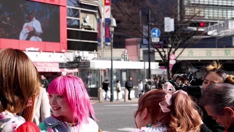 cosplayers interacting at a busy city crosswalk