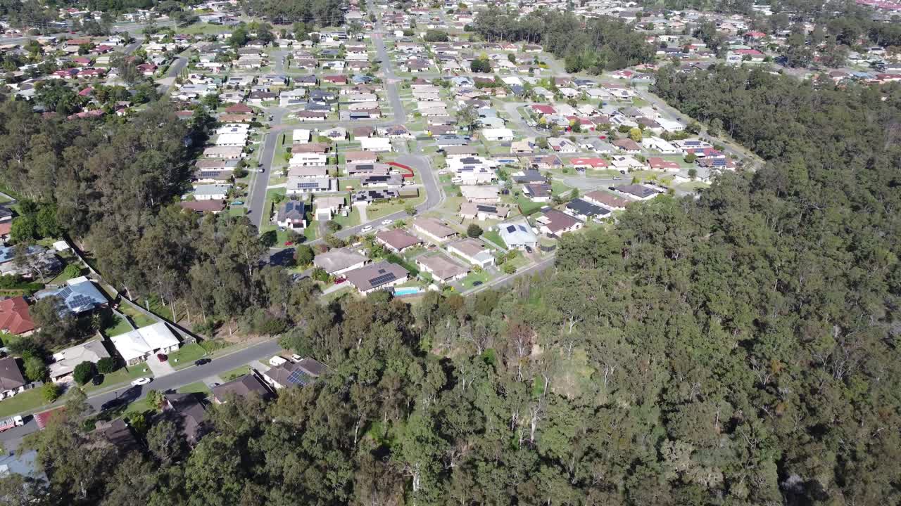 4K Drone footage flying over bushland towards a residential subdivision in Australia