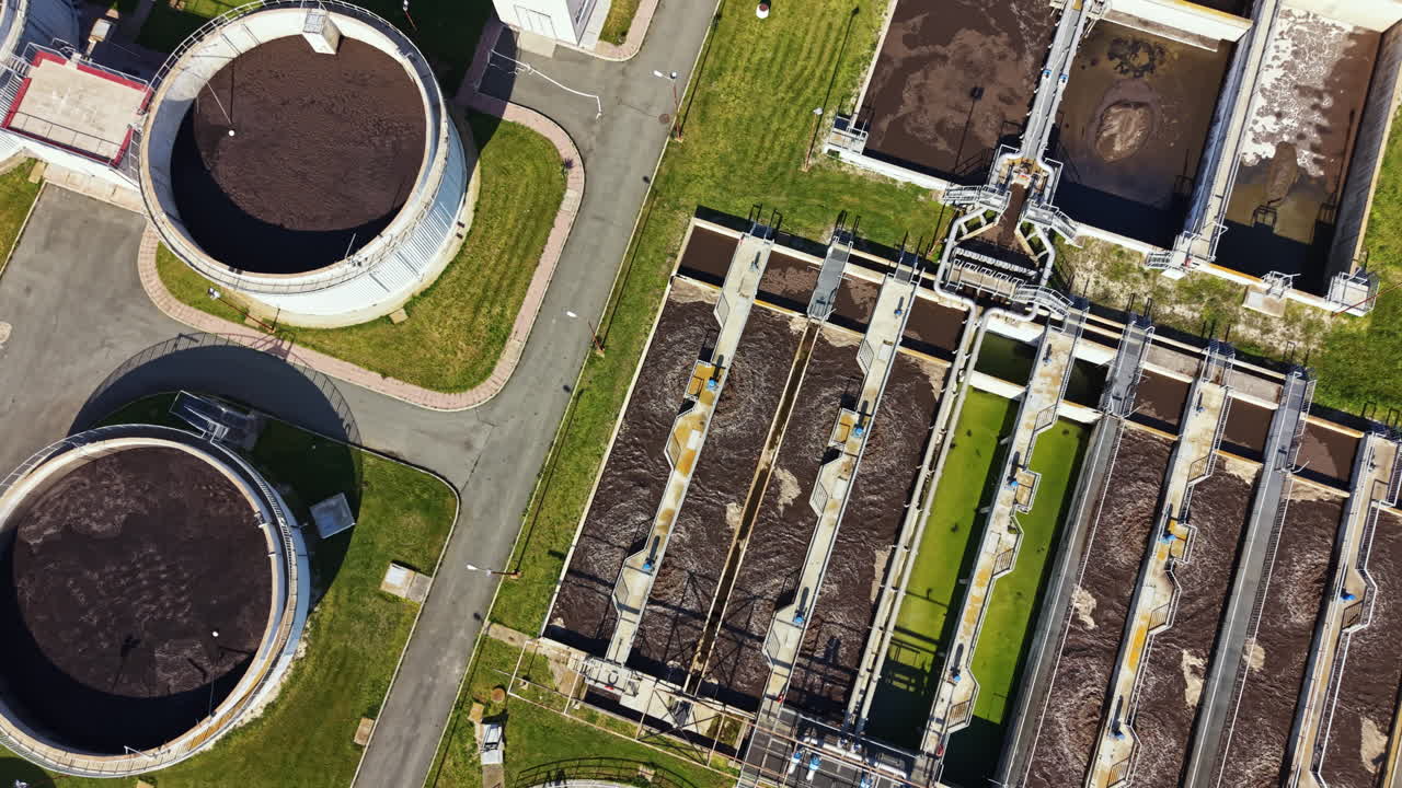 Water treatment facility processes waste and purifies water in an urban area during daylight hours