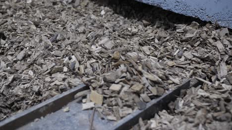 wooden-chips-closeup-pan,-bio-mass-heating-sustainable-energy,-automated-storage