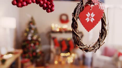 christmas grapevine wreath with ribbon hanging on window