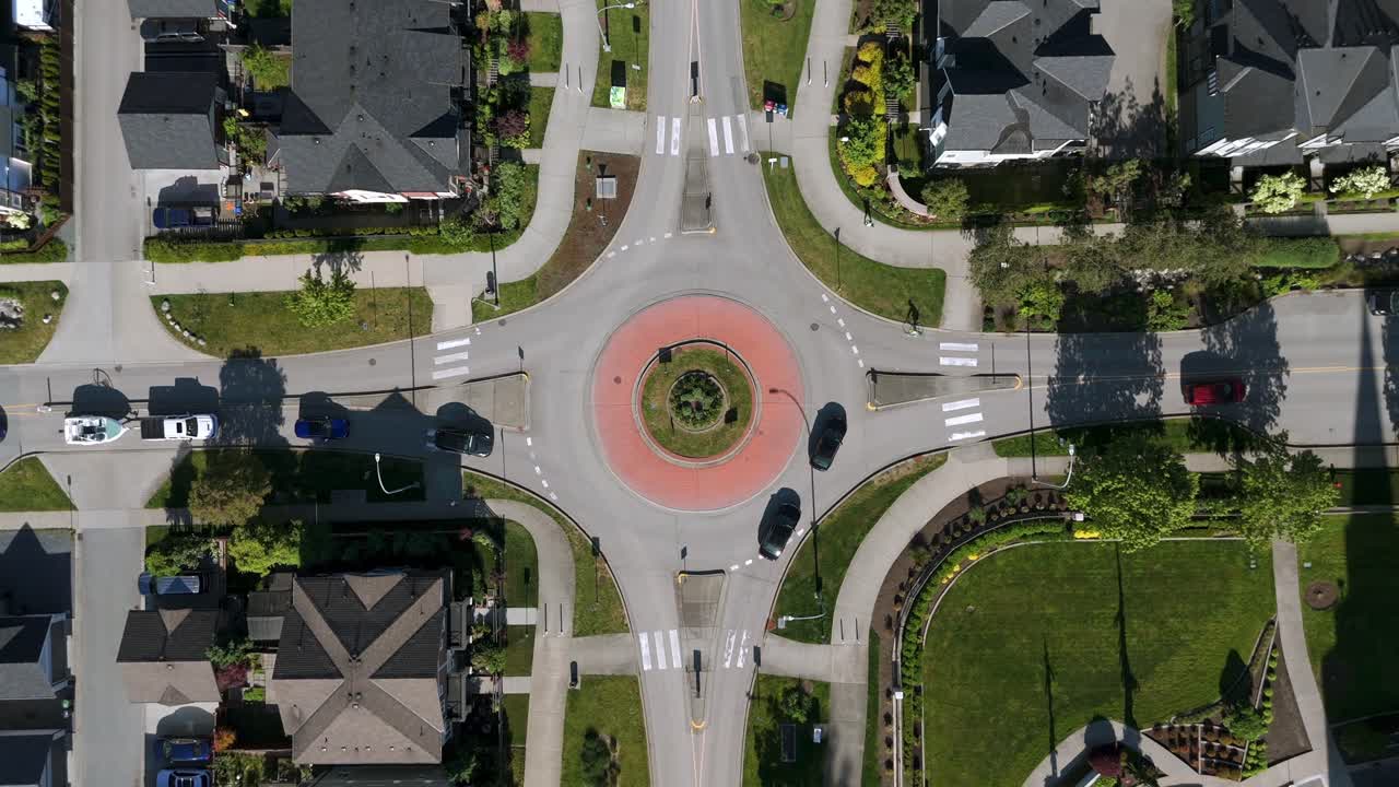 Aerial View Of Cars Driving Through Modern Roundabout In Willoughby, Langley, BC, Canada. - overhead shot