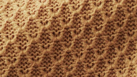 Micro-video-of-close-up-of-yellow-wooly-crochet-fabric-with-copy-space