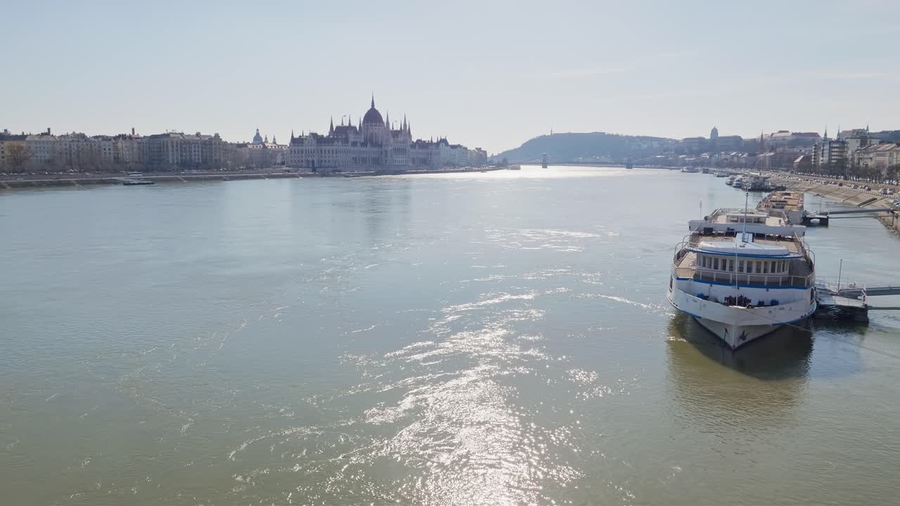 Ferry boat moored in the Danube river. Hungarian Parliament in the background. View from the Margaret bridge. Hungary