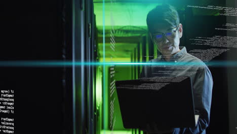 working on laptop, man in server room with coding animation over green light