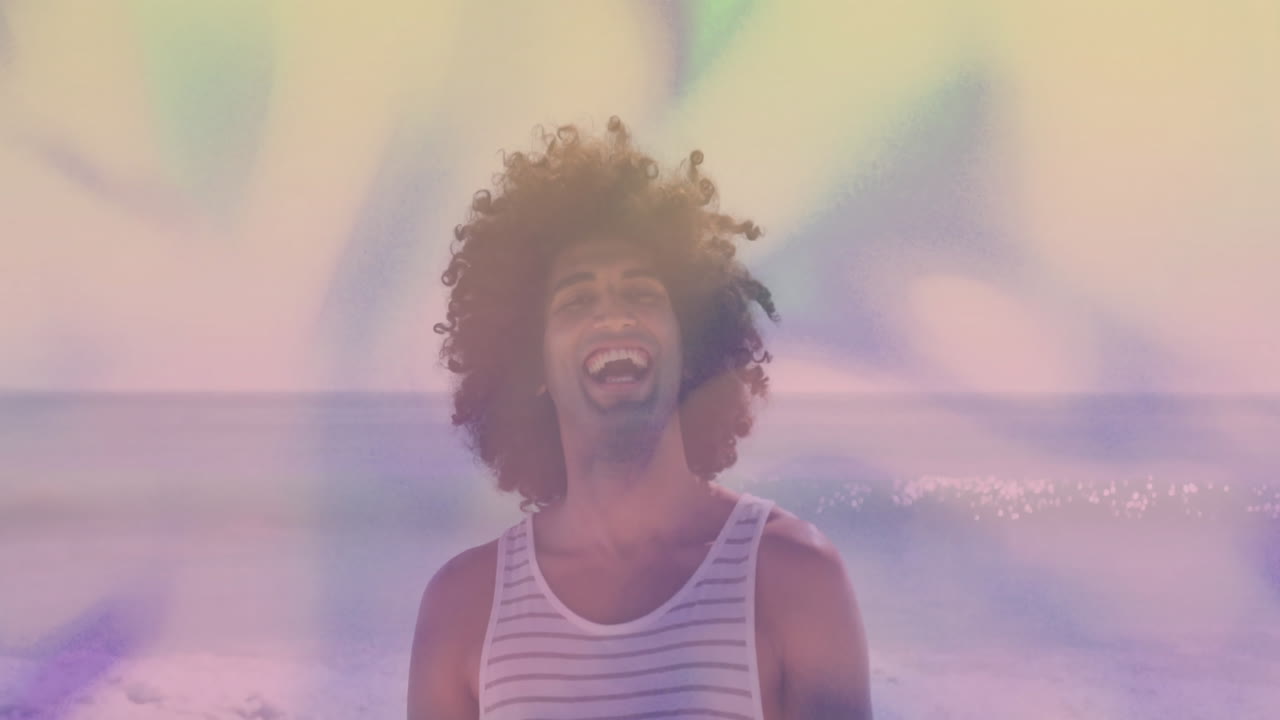 At beach, person with curly hair watching colorful animation, feeling happy