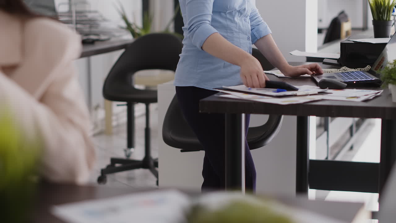 Office scene with people working and using technology