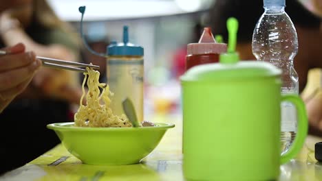 Shot-of-someone-eating-their-indonesian-food-and-playing-with-their-noodles