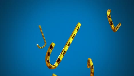 animación de las cañas de caramelo de oro de navidad cayendo sobre un fondo azul.