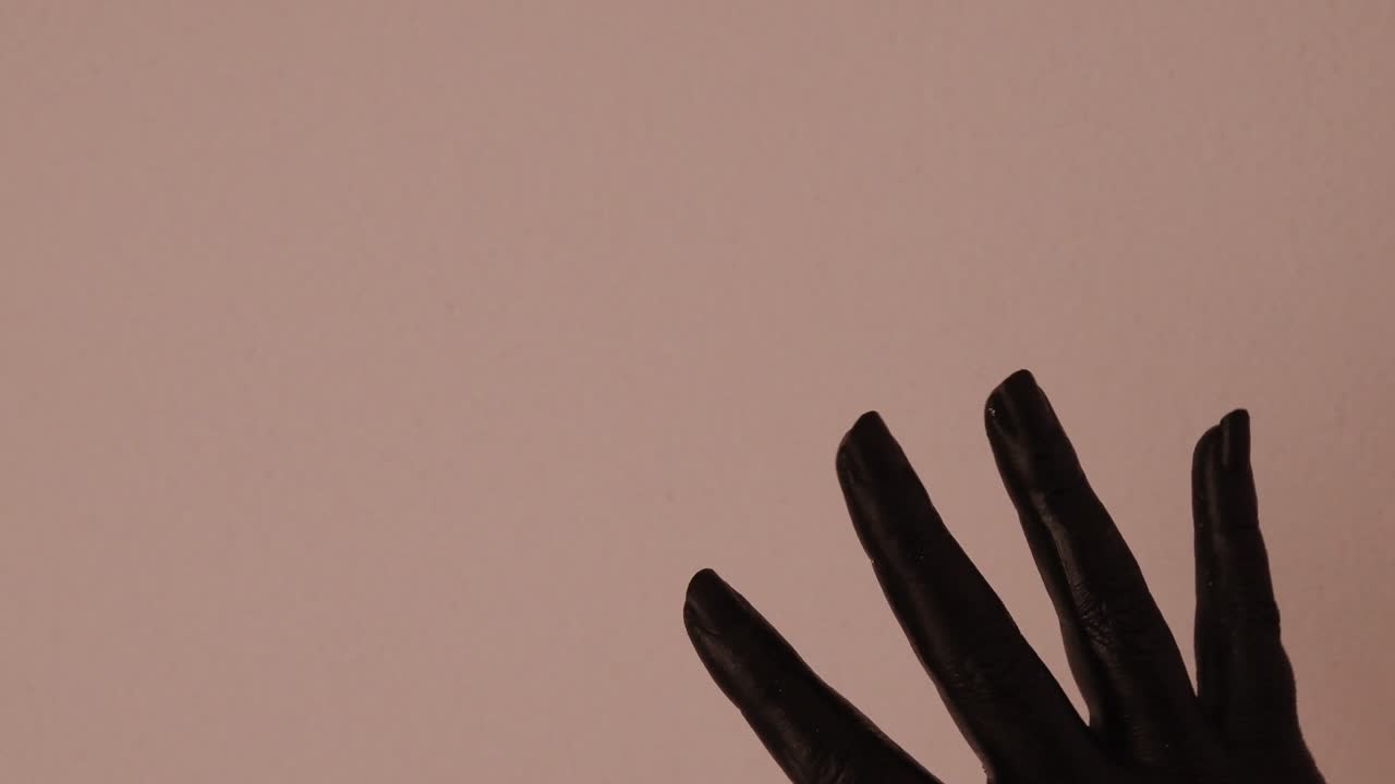 흰색 배경에서 부드럽게 움직이는 검은 색으로 칠해진 젊은 여성 손