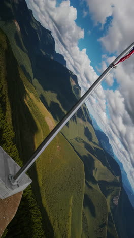 american flag flying high over mountain peaks