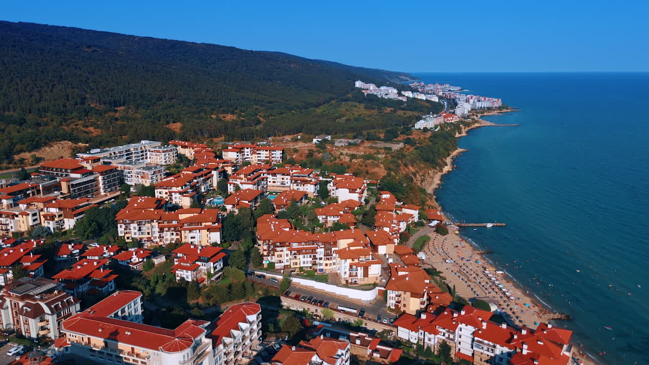 Multiple hotels with orange roofs at the rocky coast of the Black Sea. Resort area in Sveti Vlas, Bulgaria aerial view