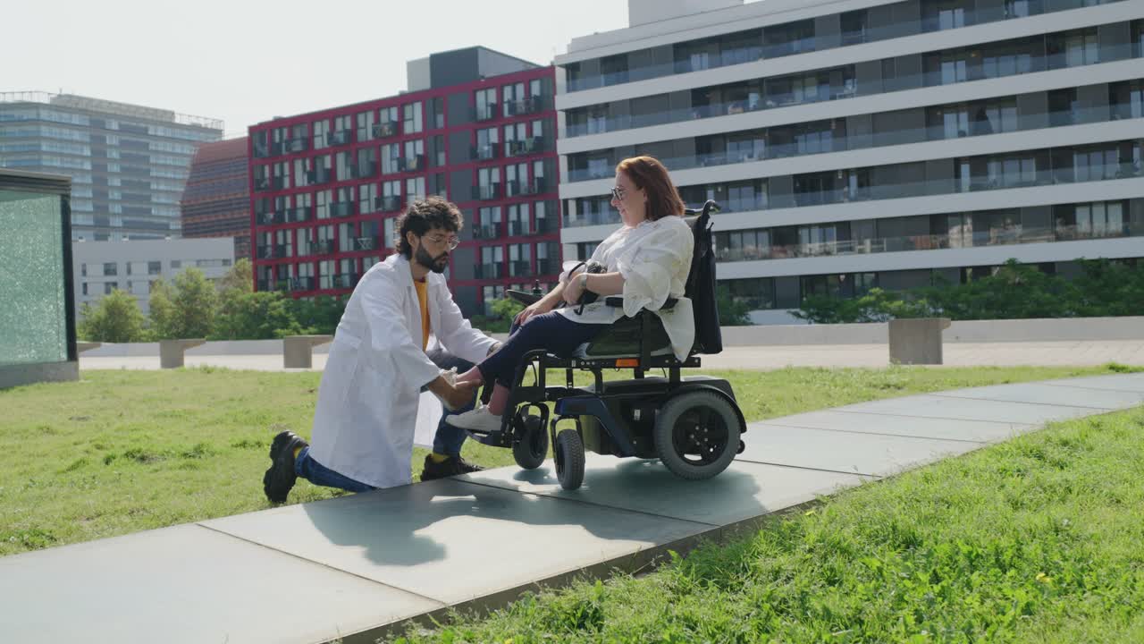 Doctor assisting patient in wheelchair