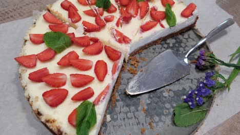 top view of fresh homemade cheesecake with strawberries and mint on metal tray, 4k