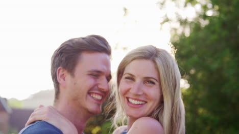 portrait of smiling couple outdoors in summer park