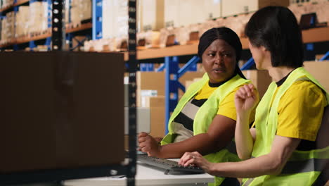 vertical video team of two workers monitoring shipping route on tracking software