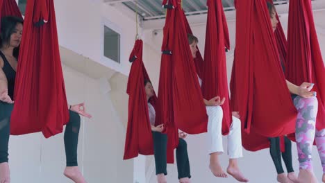 tired women sit relaxed after oriental fly yoga workout