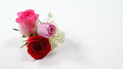 Bouquet-of-red,-white-and-pink-roses-on-black-surface-4k