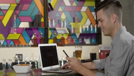 Man-using-laptop-and-mobile-phone