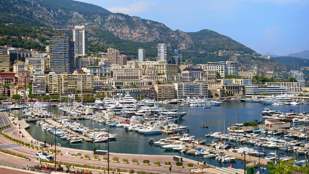 View of boats docked in the Monaco Marina with the skyline of the city on the background
